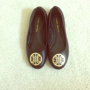 Black flats with gold piece