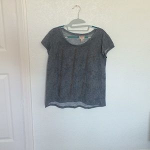 A grey shirt with bronze studs
