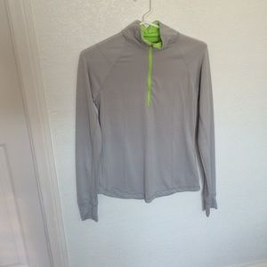 A skin tight light grey running jacket