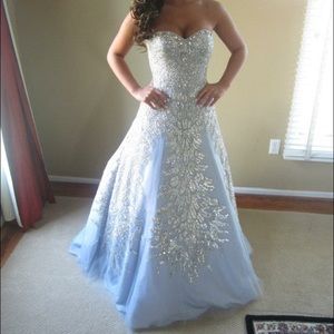 An authentic Sherri Hill silver strapless gown