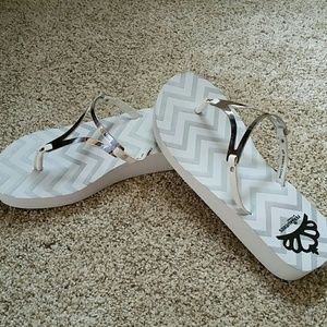White and silver flip flops