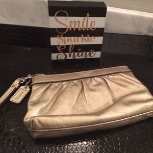 Authentic Gold Coach Wristlet.