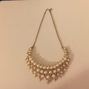 A pearl statement necklace with a gold chain