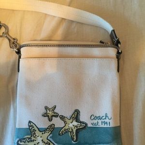 Small Coach canvas cross body purse.