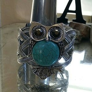 Turquoise and silver colored owl cuff bracelet