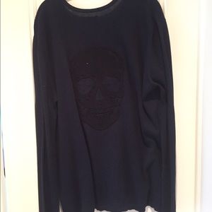 blue sweater w v neck in the front  with  skull