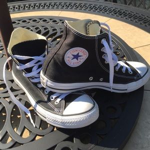Converse All Star black high top shoes.