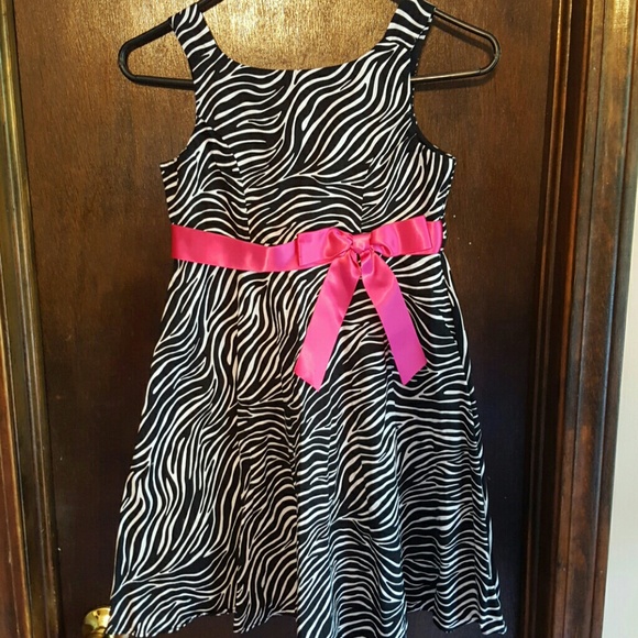 Black and white zebra dress with hot pink bow.