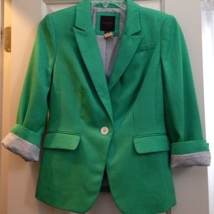 Green blazer with pinstripe detail inside sleeve.
