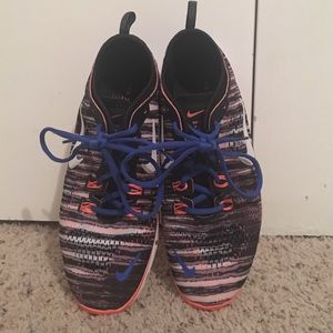 Blue, orange, and white nike shoes