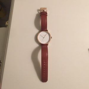 Nixon watch with brown leather band and rose gold.