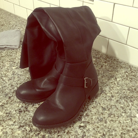 Thigh high black low heeled boots.