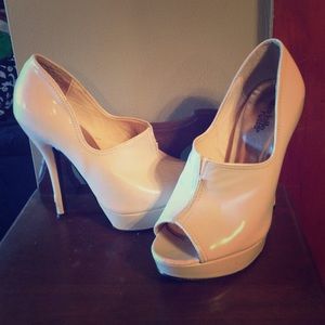 Pink patent leather peep toe heels.