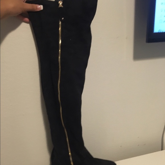 Thigh high black boots with gold detailing
