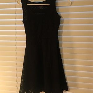 Black dress with knitting over it