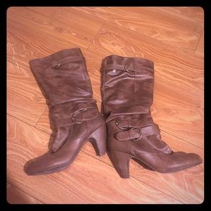 Brown boots with low heels.
