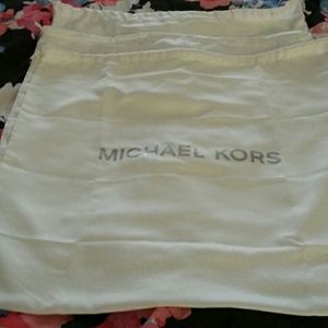 Three Michael Kors dustbags