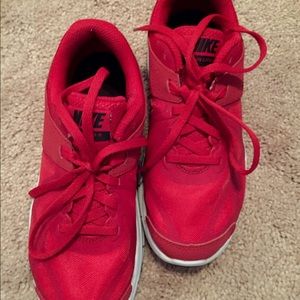 Pair lightweight red Nike running shoes.