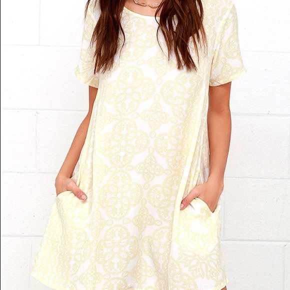Light yellow and white shirt sleeved dress