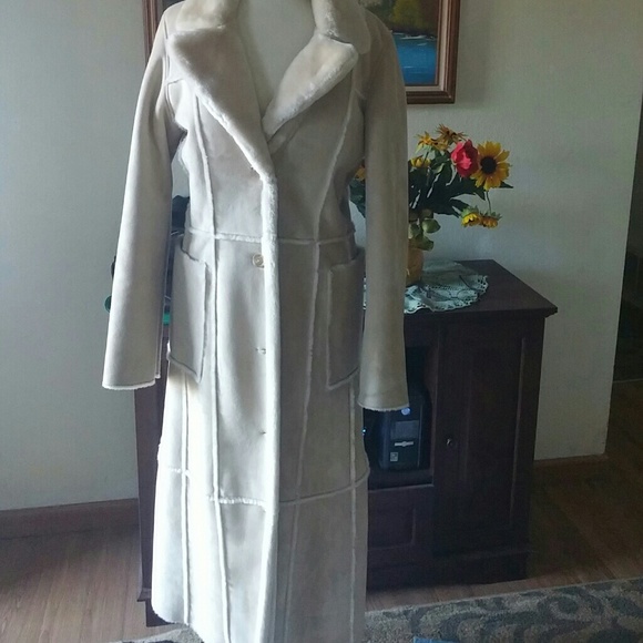 Full length fur lined creme colored coat