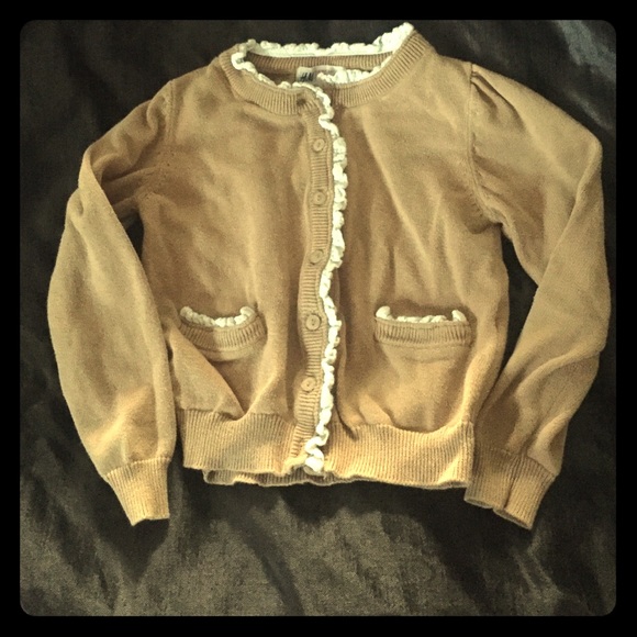 H&M tan cardigan with white ruffle trim.