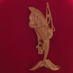 Fish holding fishing pole and bucket pin.