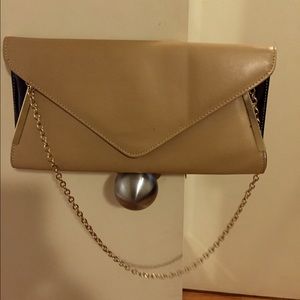 Beige and black patent leather clutch