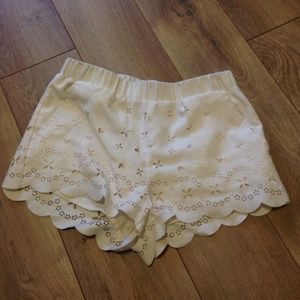 Scalloped cream shorts with cutouts