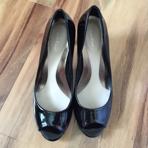 Black patent leather Calvin Klein open toe heel.