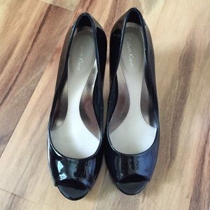 Black patent leather Calvin Klein open toe heel.