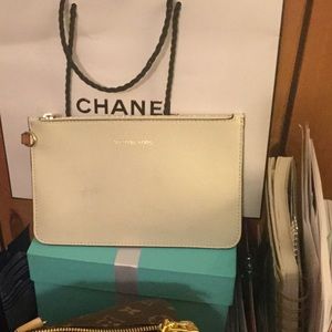 A white/ beige Mk small clutch