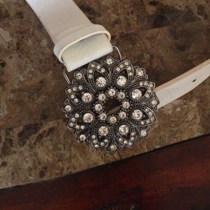 White belt with sparkly ornament.