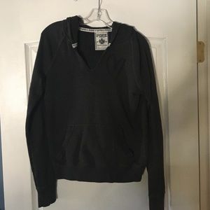 Grey pull over hoodie with darker grey writing