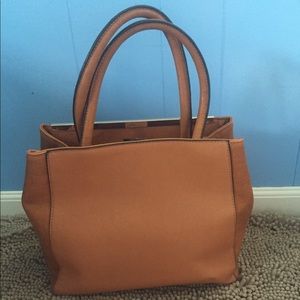 Tan Handbag with gold detail trimming.
