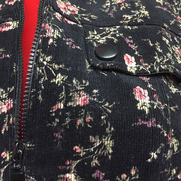 Black floral corduroy jacket with pleated skirt.