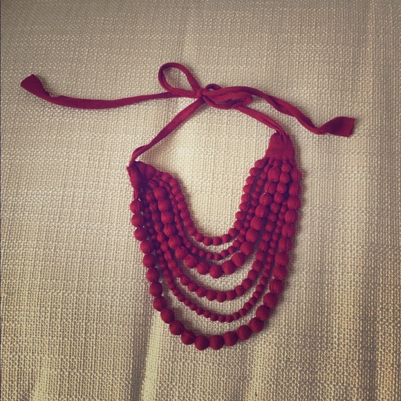 Rust colored fabric beaded necklace. Tie back.