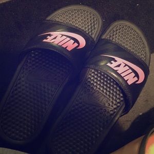 Nike black with hot pink slide sandals .