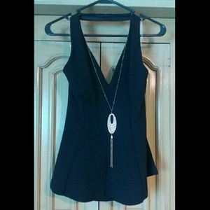 Black halter top with gold necklace.