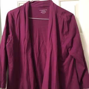 Purple pull over that falls at a slant