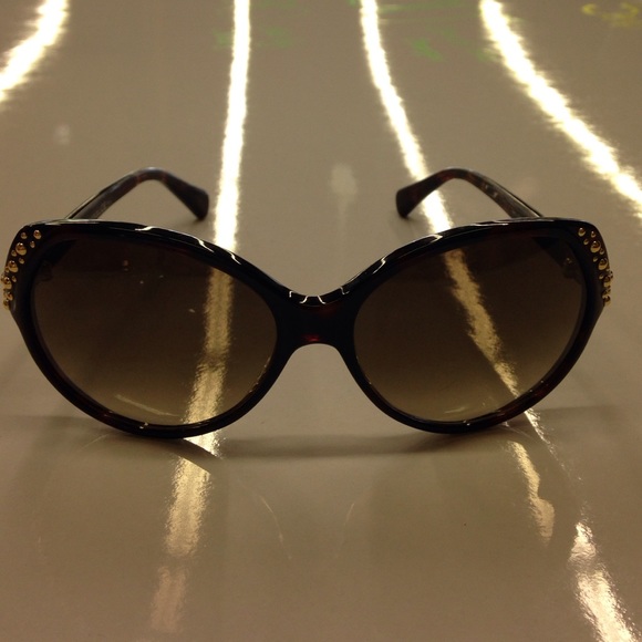 Alexander McQueen black studded oval sunglasses.