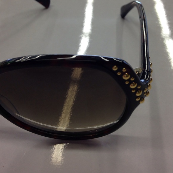 Alexander McQueen black studded oval sunglasses.