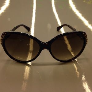 Alexander McQueen black studded oval sunglasses.