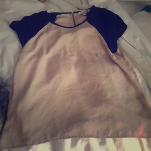 Basic beige top with black sleeves.