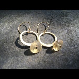 Gold hoop earrings with small yellow topaz.