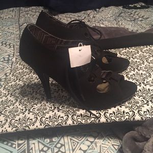 A pair of black open heels