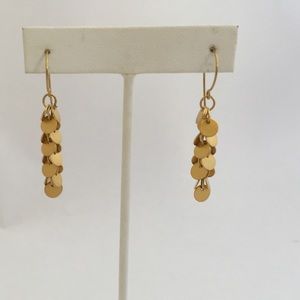 Cluster of tiny gold disk earrings.