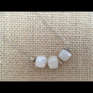 Minimalist moonstone necklace on silver chain.