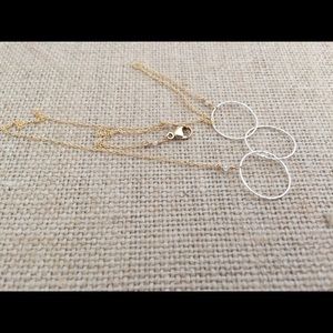 Silver and gold three entwined circle necklace.