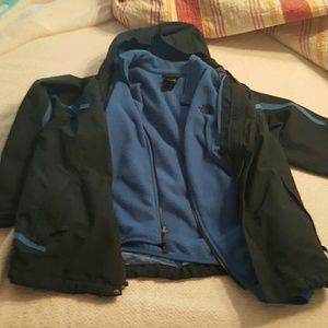 Blue North Face jackets as a pair.