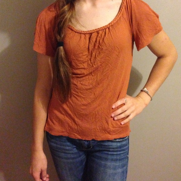 Burnt orange shirt with peek a boo shoulders.